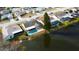Aerial view of waterfront home and pool, nestled within a quiet residential neighborhood at 4728 Swallowtail Dr, New Port Richey, FL 34653