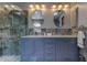 Elegant bathroom featuring a double sink vanity, marble countertop, and a modern glass-enclosed shower at 4728 Swallowtail Dr, New Port Richey, FL 34653