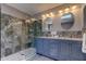 Stylish bathroom featuring a double sink vanity with marble countertop and elegant glass-enclosed shower at 4728 Swallowtail Dr, New Port Richey, FL 34653