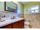 Bathroom featuring a vanity with a quartz countertop, a tiled backsplash, and modern fixtures at 4728 Swallowtail Dr, New Port Richey, FL 34653