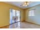 Bedroom area with tile floor, ceiling fan and sliding glass doors that open to the screened patio at 4728 Swallowtail Dr, New Port Richey, FL 34653
