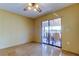 Bedroom featuring tile floor, ceiling fan, and sliding glass doors that open to a screened patio at 4728 Swallowtail Dr, New Port Richey, FL 34653