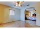 Spacious bedroom with neutral walls, tile floor, ceiling fan and partial view of second connected bedroom at 4728 Swallowtail Dr, New Port Richey, FL 34653