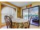 Cozy breakfast nook with view of outdoor pool through sliding glass doors at 4728 Swallowtail Dr, New Port Richey, FL 34653
