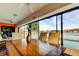 Dining area showcases beautiful pool and lake views, with large windows offering bright natural light, creating a welcoming atmosphere at 4728 Swallowtail Dr, New Port Richey, FL 34653