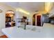 Bright kitchen featuring stainless fixtures, white cabinetry and arched entry to dining area at 4728 Swallowtail Dr, New Port Richey, FL 34653