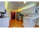 Spacious kitchen featuring stainless steel appliances, white cabinets, and wood-look flooring at 4728 Swallowtail Dr, New Port Richey, FL 34653