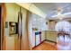 Stainless steel refrigerator stands out in a well-lit kitchen with wood floors and matching dishwasher at 4728 Swallowtail Dr, New Port Richey, FL 34653