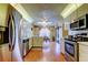 Bright eat-in kitchen features stainless steel appliances, white cabinetry, and hardwood floors at 4728 Swallowtail Dr, New Port Richey, FL 34653