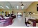 Bright living room with tile flooring, skylights, and access to the dining area at 4728 Swallowtail Dr, New Port Richey, FL 34653