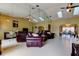 Open-concept living area with tile flooring, skylights, and a mirrored wall at 4728 Swallowtail Dr, New Port Richey, FL 34653