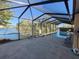 Spacious screened-in pool area with comfortable seating, providing a relaxing space to enjoy the pool and lake views at 4728 Swallowtail Dr, New Port Richey, FL 34653