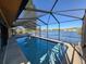 Inviting screened-in pool offers tranquil views of the lake, perfect for enjoying a swim and the beautiful scenery at 4728 Swallowtail Dr, New Port Richey, FL 34653