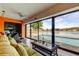 Cozy sunroom offering picturesque views of the pool and lake through large sliding windows, perfect for lounging at 4728 Swallowtail Dr, New Port Richey, FL 34653