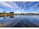 Scenic waterfront showcasing clear reflections of the sky and surrounding homes at 4728 Swallowtail Dr, New Port Richey, FL 34653