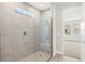 Modern bathroom featuring a glass-enclosed shower with gray stone tile at 11683 Rose Gold Ct, Venice, FL 34293