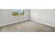 Bedroom with a large window and neutral carpeting at 11683 Rose Gold Ct, Venice, FL 34293
