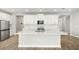 Modern kitchen featuring white cabinetry, a center island with a sink, and stainless steel appliances at 11683 Rose Gold Ct, Venice, FL 34293