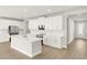 Bright kitchen with white cabinets, stainless appliances, large island, and modern finishes at 11683 Rose Gold Ct, Venice, FL 34293