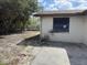 Exterior view of a single-story home showing the yard and back patio at 12812 1St Isle, Hudson, FL 34667