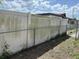 View of the backyard showing a weathered fence with some discoloration and vegetation at its base at 12812 1St Isle, Hudson, FL 34667