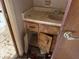 Bathroom vanity with sink, damaged cabinet, and plumbing at 12812 1St Isle, Hudson, FL 34667