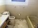 Bathroom featuring tub, toilet, vanity, and tiled walls at 12812 1St Isle, Hudson, FL 34667