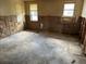 Stripped bedroom showing damage to walls, floor, and window frames at 12812 1St Isle, Hudson, FL 34667
