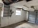 Interior view of garage featuring door, walls, and lighting at 12812 1St Isle, Hudson, FL 34667