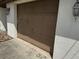 Close-up of the garage door with an exterior light fixture, highlighting parking space and potential storage at 12812 1St Isle, Hudson, FL 34667