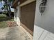 Garage view with an exterior light fixture, highlighting the parking space and potential storage area at 12812 1St Isle, Hudson, FL 34667