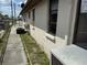 Exterior view of the house showcasing the side with weathered texture and some utilities, showing deferred maintenance at 12812 1St Isle, Hudson, FL 34667