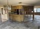 Open kitchen with potential for updates, featuring ample countertop space and natural lighting at 12812 1St Isle, Hudson, FL 34667