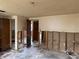 Spacious living room with damaged drywall and view to hall at 12812 1St Isle, Hudson, FL 34667