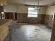 Open living room space featuring a chandelier, window, and exposed insulation at 12812 1St Isle, Hudson, FL 34667