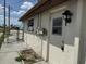 Side entrance view of the home, showcasing the door and electrical features, with some repairs needed at 12812 1St Isle, Hudson, FL 34667