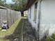 Showing the side yard area with a fence, shed, and yard equipment at 12812 1St Isle, Hudson, FL 34667