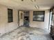 Sun room view of open doorway to kitchen, ceiling stains and three windows at 12812 1St Isle, Hudson, FL 34667