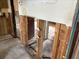 Exposed interior wall studs leading to open doorway to kitchen and dining area at 12812 1St Isle, Hudson, FL 34667