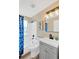 Stylish bathroom with a blue patterned shower curtain and a modern vanity with ample storage at 12918 Cambridge Ave, Tampa, FL 33624