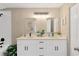 Bright bathroom featuring double vanity with framed mirrors and modern fixtures at 12918 Cambridge Ave, Tampa, FL 33624