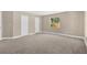 Bright, spacious bedroom with neutral carpeting and large windows at 12918 Cambridge Ave, Tampa, FL 33624