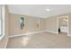 Spacious bedroom with neutral carpeting and three large windows with an ensuite bathroom at 12918 Cambridge Ave, Tampa, FL 33624