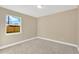 Bright bedroom with a window, neutral paint, and carpet flooring for a comfortable and serene space at 12918 Cambridge Ave, Tampa, FL 33624