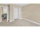 Cozy bedroom featuring neutral walls, carpet floors, and a closet with folding doors at 12918 Cambridge Ave, Tampa, FL 33624