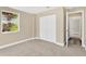 Cozy bedroom with a built-in closet, large window, and carpet flooring for a comfortable living space at 12918 Cambridge Ave, Tampa, FL 33624