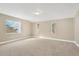 Spacious bedroom with neutral carpeting and three large windows offering ample natural light at 12918 Cambridge Ave, Tampa, FL 33624