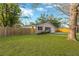 Charming home with a well-manicured lawn, wood fence, and beautiful landscaping at 12918 Cambridge Ave, Tampa, FL 33624