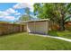 Backyard shed with a covered overhang, offering additional storage space at 12918 Cambridge Ave, Tampa, FL 33624