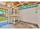 Interior of shed featuring workbench and shelving with outdoor view at 12918 Cambridge Ave, Tampa, FL 33624